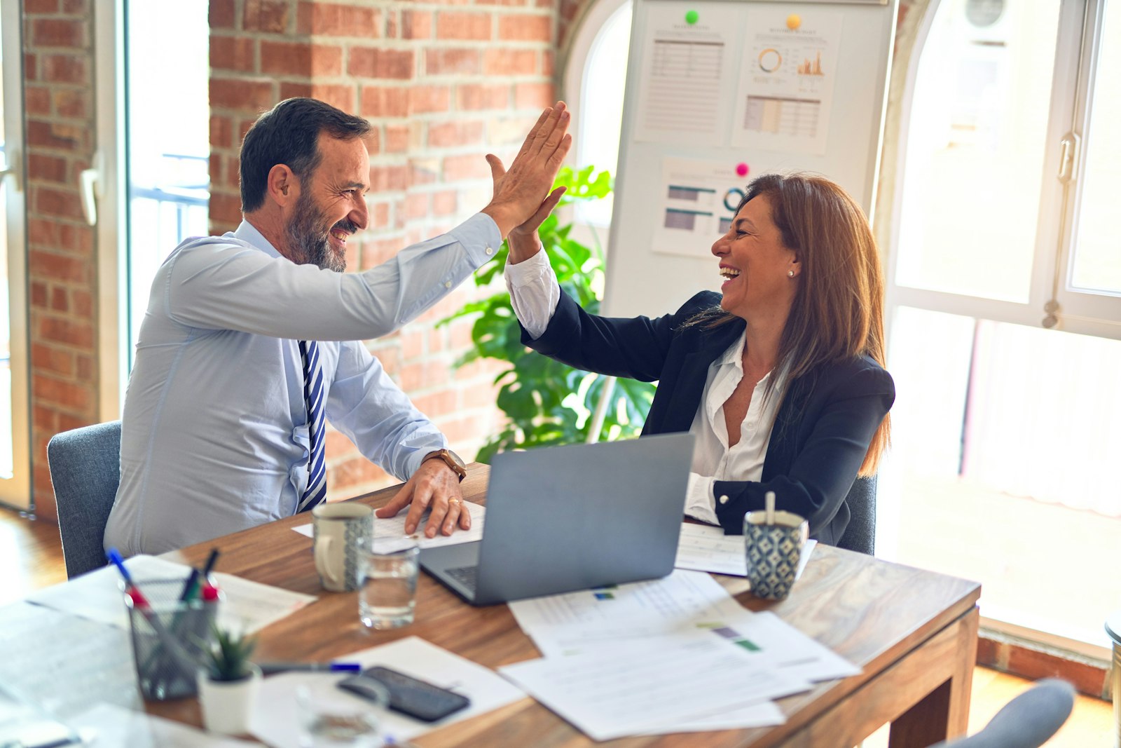 Business professionals collaborating over a laptop in an office